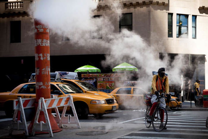 A cyclist and taxicabs in New York City