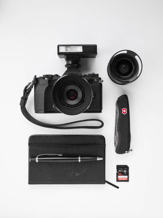 Flat lay of accessories to take with you on your street photography journey