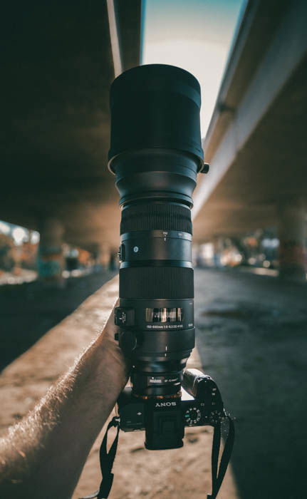 A DSLR with a large lens for street photography