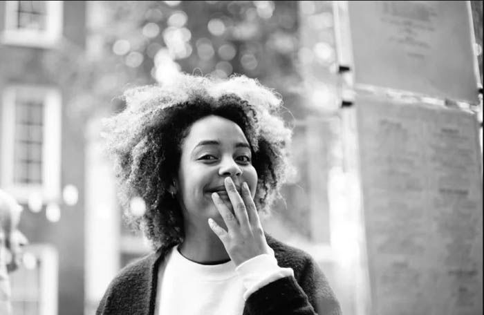 A black and white portrait of a woman using a 50mm lens