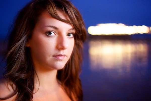 Portrait photography of a girl on a beach. Twilight photography.