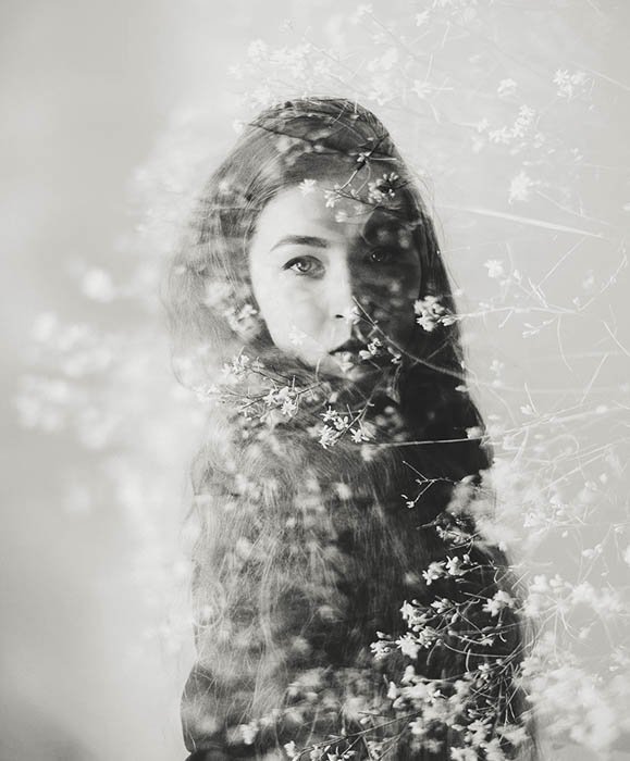 Black and white double exposure effect of flowers over a female model