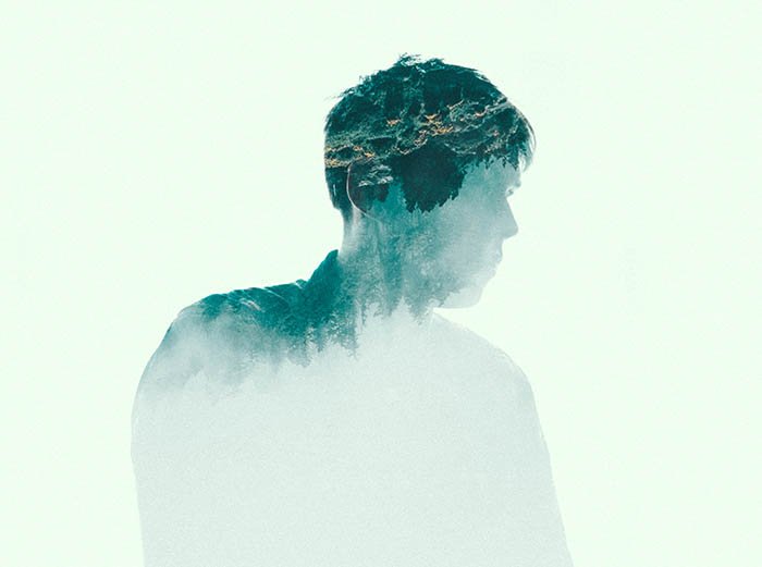 double-exposure image of a male silhouette and a forest