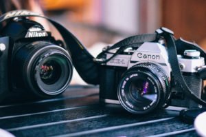 A Nikon DSLR next to a Canon Single-Lens Reflex