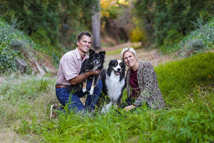 family portrait of a couple and their dogs