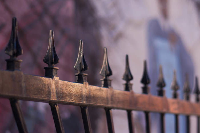 an example of pattern in photography showing the iron spikes of a fence