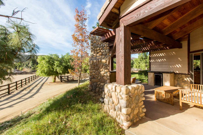 Real estate photo depicting the front porch of a house and the road leading up to it