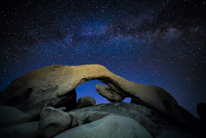 A star filled sky over a rock formation
