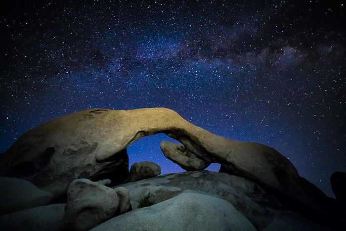 A star filled sky over a rock formation