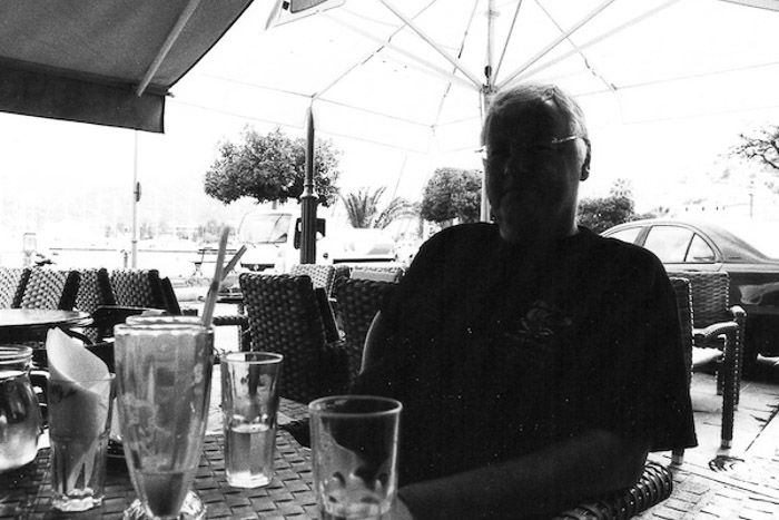 A portrait of a man sitting in an outdoor cafe - tips for shooting with black and white film photography