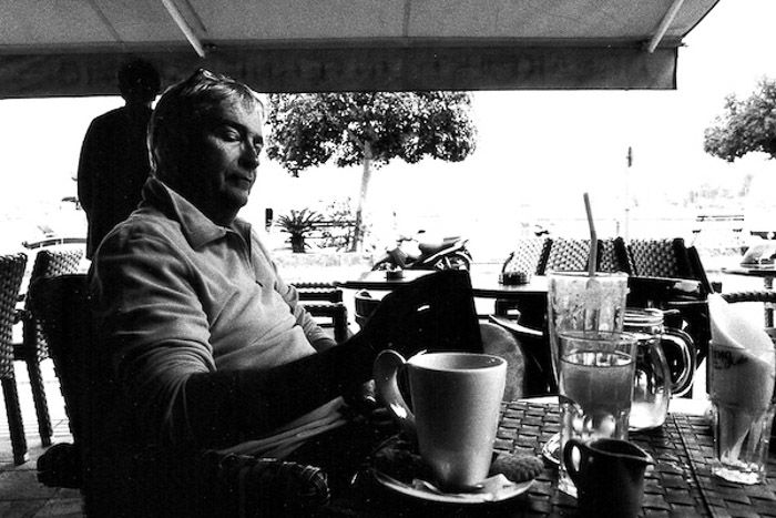 A portrait of a man sitting in an outdoor cafe - tips for shooting with black and white film photography