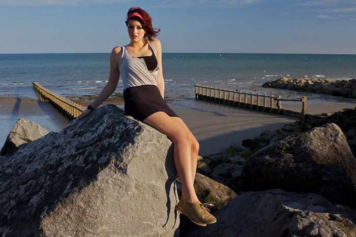 A portrait of a girl posing on rocks using diagonal lines in photography composition