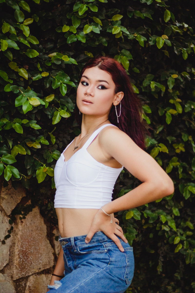 Waist-up Portrait Of Beautiful Young Woman Posing For Photography While  Standing Against Shelves Of Beauty Store Stock Photo, Picture and Royalty  Free Image. Image 99814991.