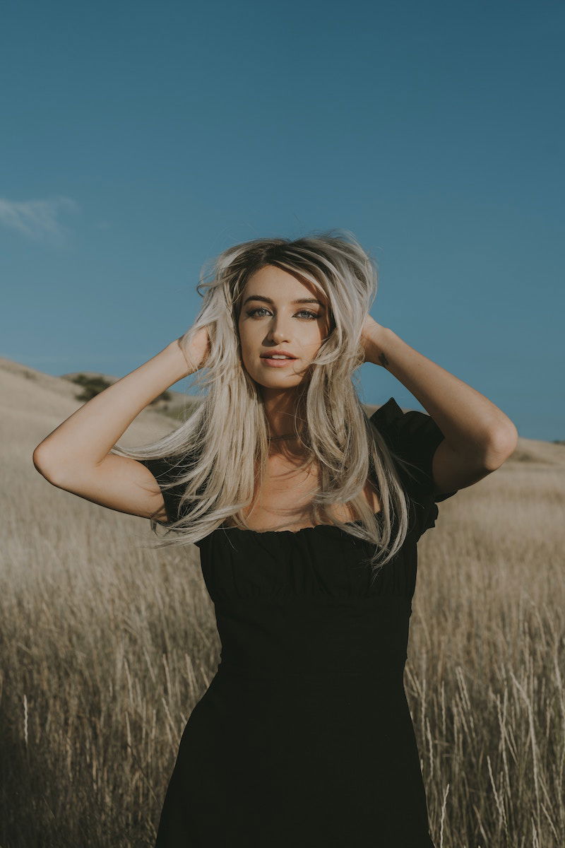 female poses hands in hair