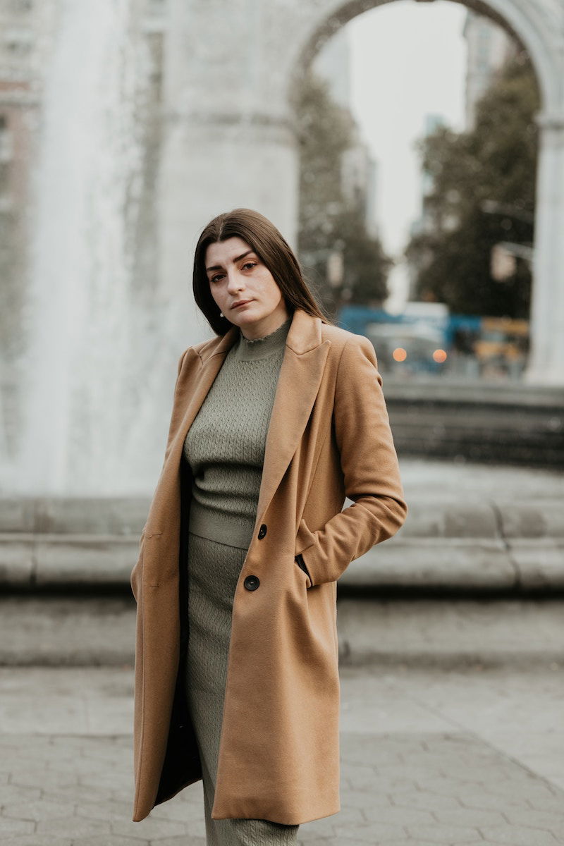 Woman standing with her hands in her jacket pockets