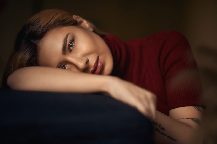 A woman posing with her head on her arm