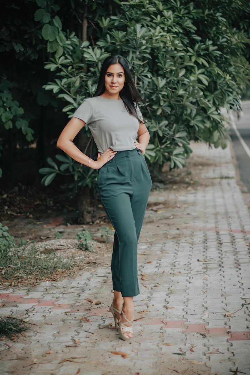 A woman standing with one leg in front of the other