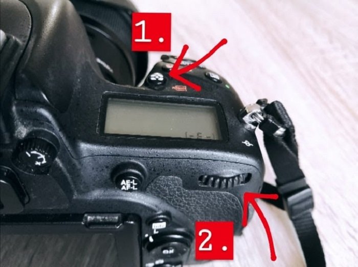 A close up of changing a cameras metering mode