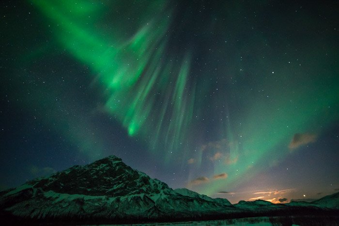 The northern lights over a mountainous landscape 