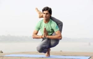A yoga teacher doing an advance pose with his leg over his head as an example of yoga photography