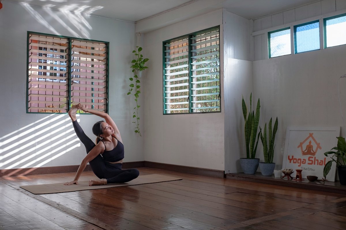 An advanced yogini doing a compass pose in a studio as an example of yoga photography