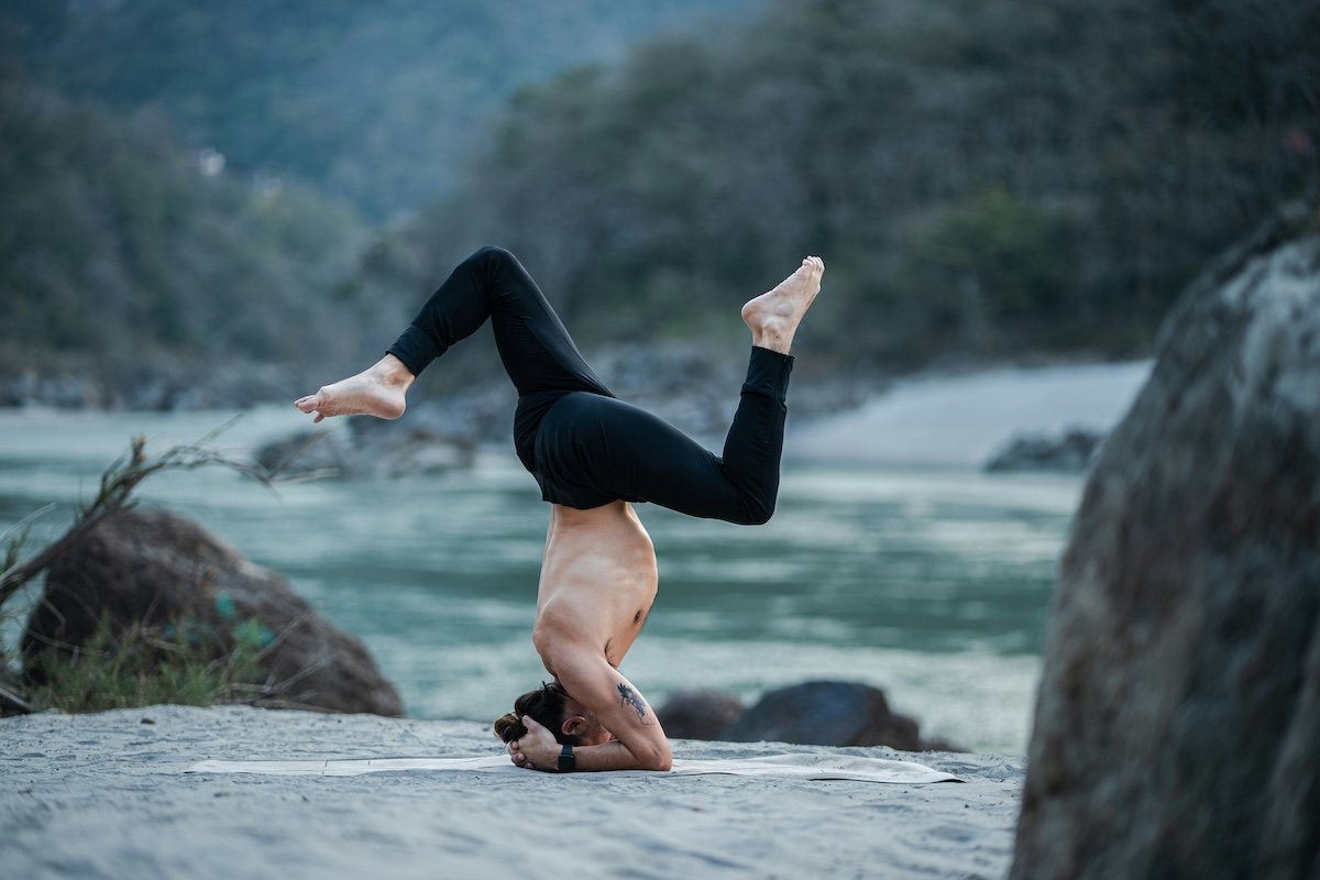 Yogi doing a headstand outside as an example of yoga photography