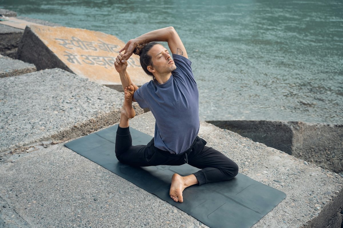 A man doing a pigeon pose shot at a high angle as an example of yoga photography