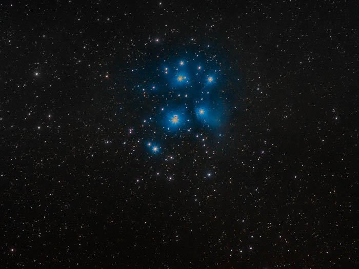 Pleiades and their classic blue nebulosity