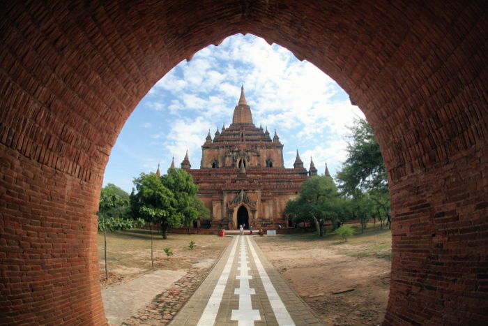 photo of an ancient temple shot from a tunnel