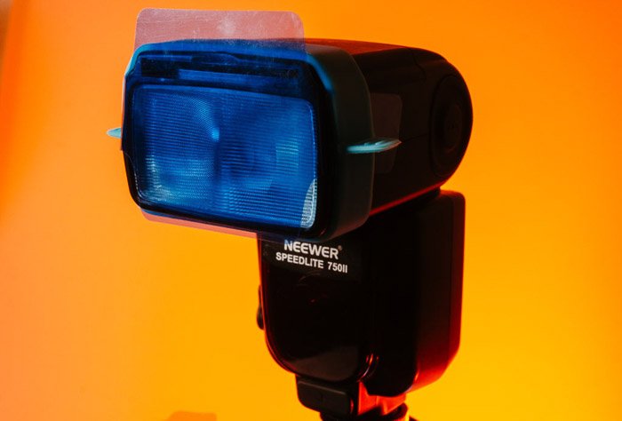 A flash with color gel lighting attached