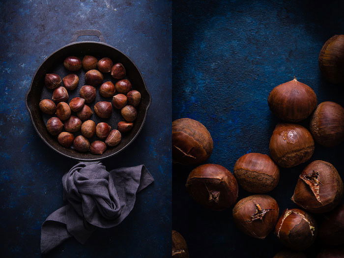 Chestnuts sit in a pan on a dark blue background