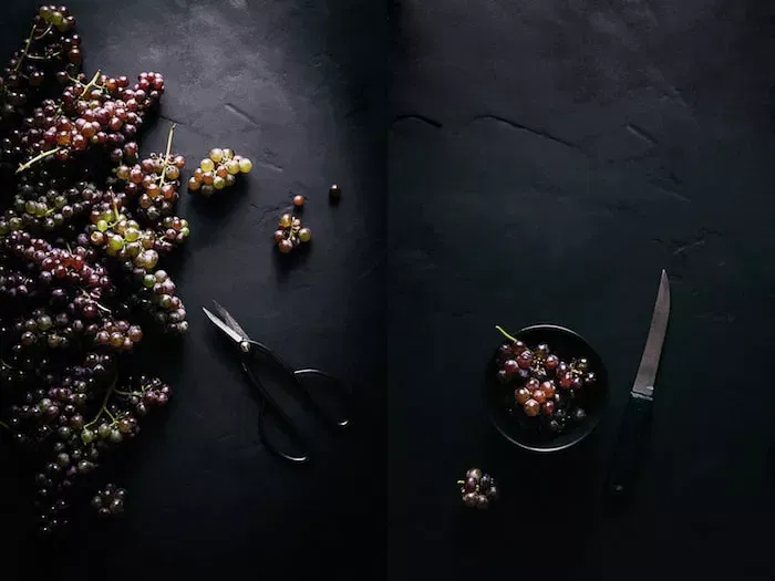 Grapes on a dark surface.