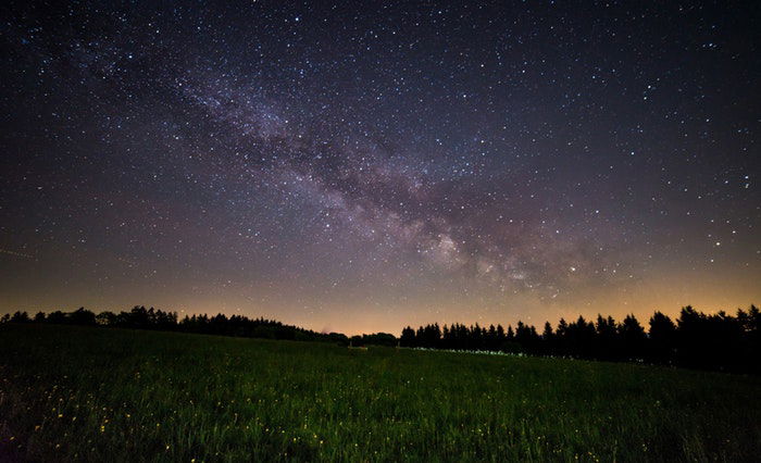 A landscape photo at night with the milky way 