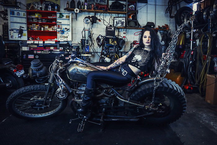 Female model posing on a motorbike