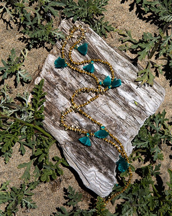 A jewellery product shot on a piece of wood outdoors