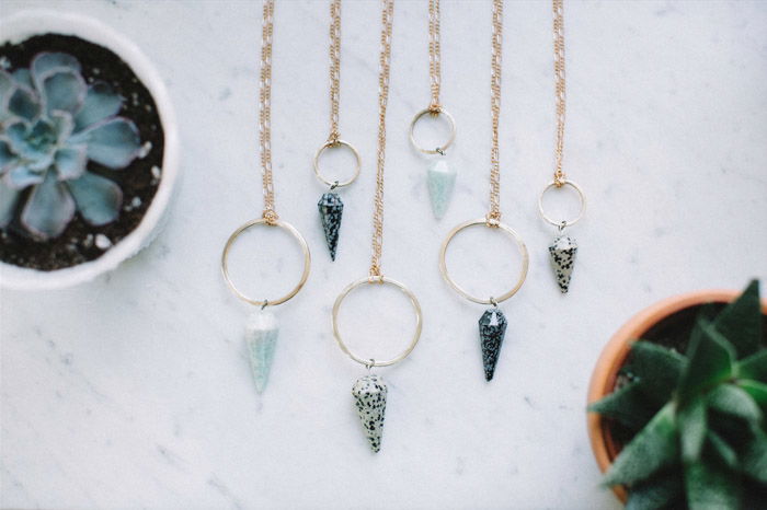 Necklaces draped on a marble worktop 