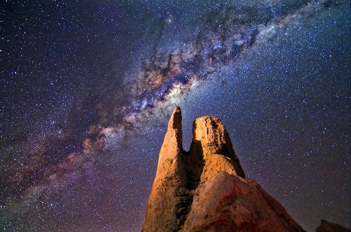 A rock formation with the Milky Way above 