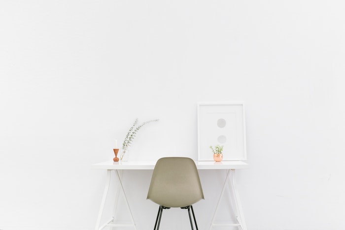 A chair and desk in front of a white background