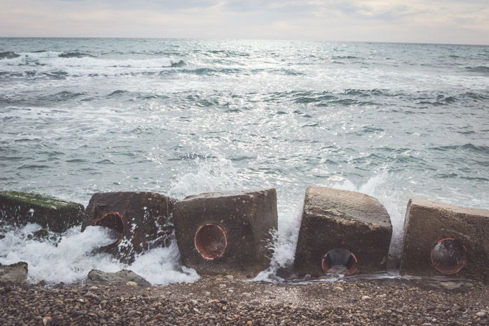 A picture of a beach with waves breaking on the shore