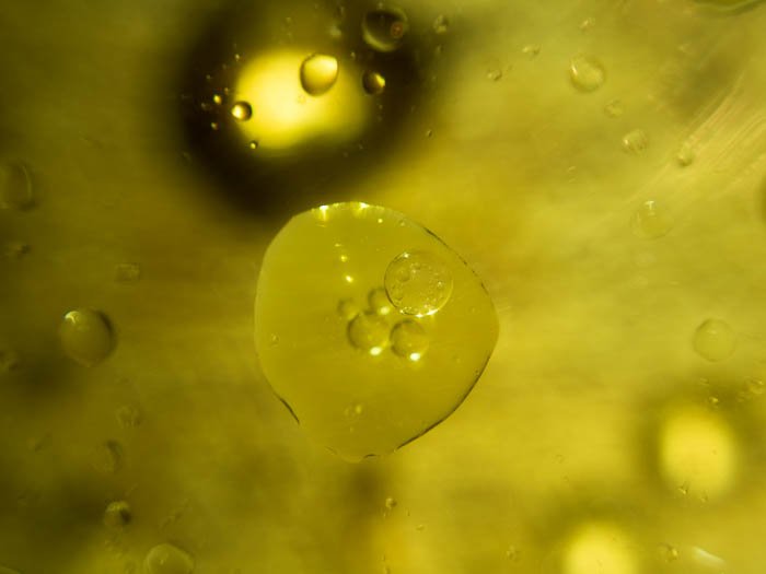 Yellow oils drops in water