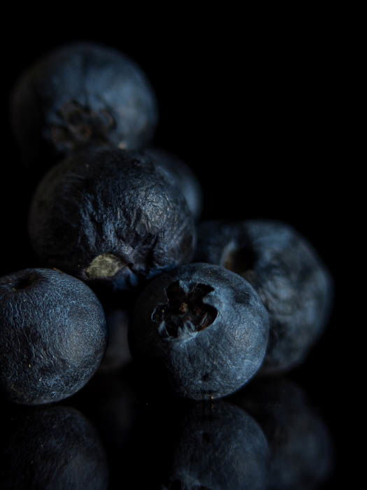 Black pepper in front of a black background