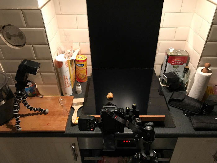 Makeshift studio in the kitchen with a camera and a flash