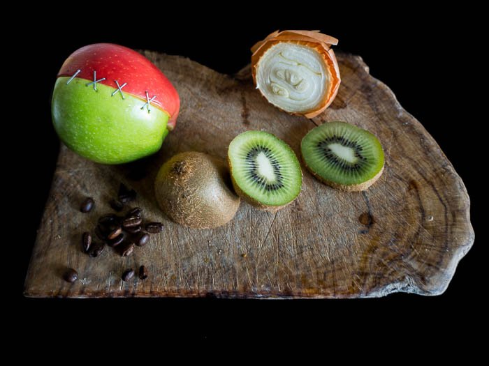 Kiwi, onion, coffee and two half apples sewed together on a wooden plate - Macro photography tips