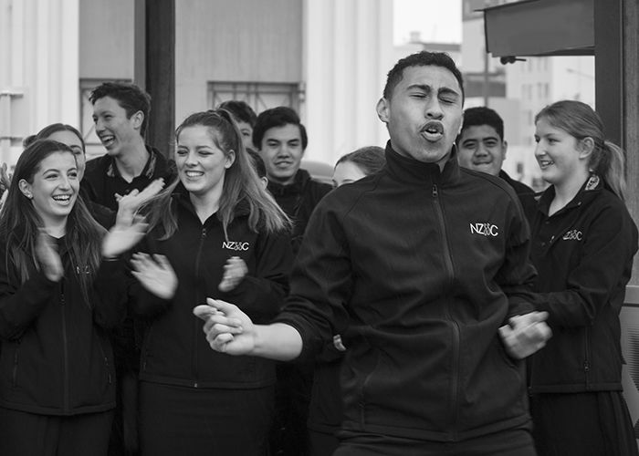 black and white documentary photography of a group of people singing and clapping