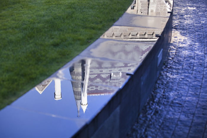 reflected image of Christchurch arts center on a wet wall