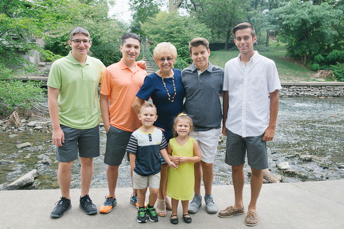 A family of seven posing outdoors