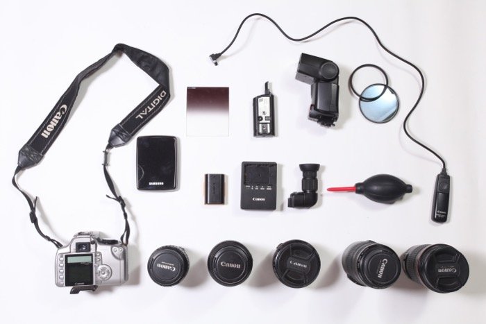 A flat lay of various travel photography accessories