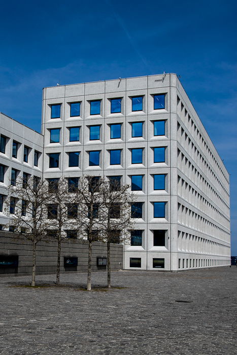 photo of a multi windowed building on a clear day with the blue skies reflected in the windows