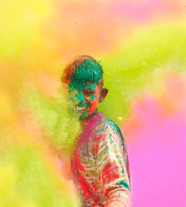 A colourful photograph of a young boy painted for a celebration