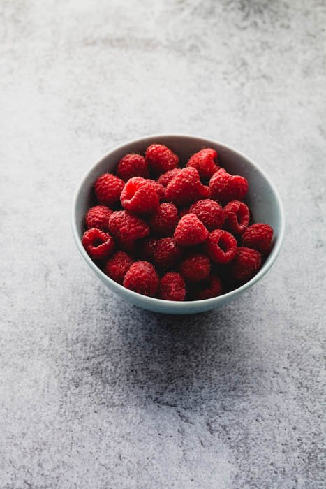 fresh raspberries in a blue bowl